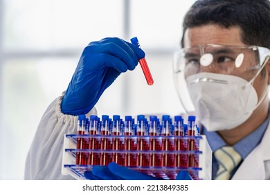 Doctor's Hand Holding A Bottle Of Blood Sample Test Tube With Blood Test Without Inscription Spot Focus, Macro, Copy Area