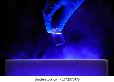 Doctor's Hand Holding Bottle Vaccine From Storage Box. Medication Treatment Concept.