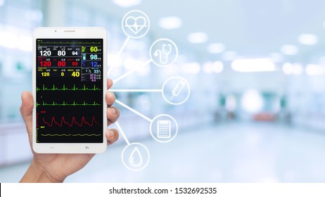 Doctor's Hand Holding Smart Phone / Tablet Show Internet Online Patient Monitoring Systems. Concept Of Telemedicine , Online Medical Consultation.