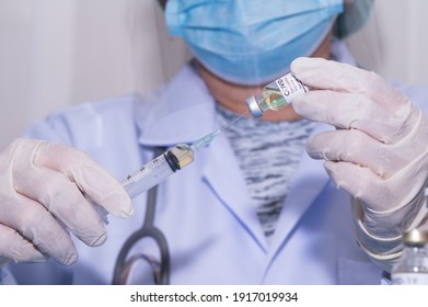 Doctor's hand holding syringe and bottle for vaccination.Vaccine for protection Coronavirus (Covid-19) infection.Vaccination for coronavirus treatment.