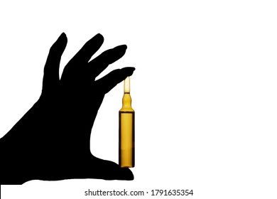 The doctor's hand holds an ampoule of medicine on a white isolated background. The vaccine for coronavirus. Copy space