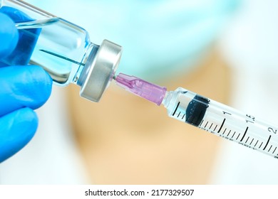 doctor's hand holds a syringe and a blue vaccine bottle at the hospital. Health and medical concepts. - Shutterstock ID 2177329507