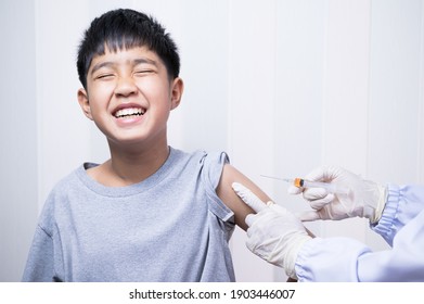 Doctor's hand injecting for vaccination in the shoulder kid patient.Vaccine for protection Coronavirus (Covid-19) infection with Asian boy.Vaccination for coronavirus treatment. - Powered by Shutterstock