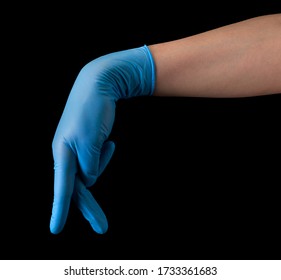 Doctor's Hand In Sterile Medical Gloves Show Walking Finger Isolated On Black Background With Clipping Path. Concept Of Social Distancing With Copy Space Concept