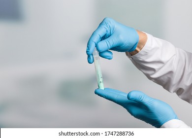 Doctor's hand with a test tube for stool sample for colon cancer screening 
