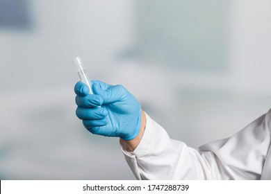 Doctor's Hand With A Test Tube For Stool Sample For Colon Cancer Screening 