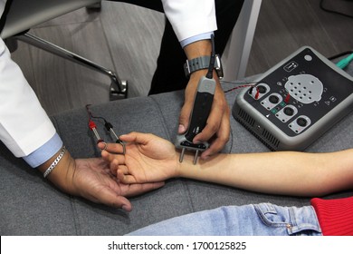 
doctor's hands conducting electromyography study and nerve conduction in young woman - Shutterstock ID 1700125825