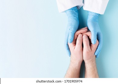 Doctor's hands in gloves holding man's hands. Medical background with copy space. Care concept. - Powered by Shutterstock