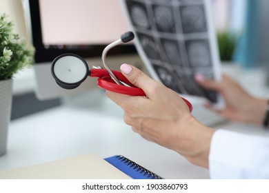 Doctor's Hands Are Holding Stethoscope And Pictures Of Brain. Magnetic Resonance Imaging Of Brain Concept