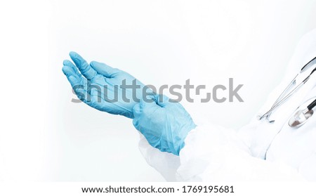 doctor's hands in surgical gloves on a white background