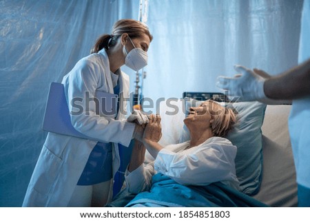 Similar – Grateful senior female patient giving gift to female doctor