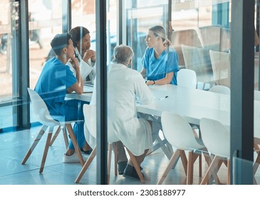 Doctors, healthcare team and meeting for a discussion, planning or training at table. Diversity men and women medical group talking about communication strategy, virus or surgery in a hospital - Powered by Shutterstock