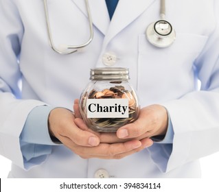 Doctors Hold Money Jar. Concept Of Charity , Donate For  Procurement Of Medical Equipment And Help Poor Patients