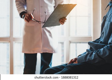Doctors hold papers to check the sexual health of a male patient. Concept of male health problems.