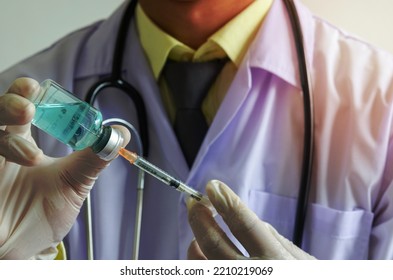 Doctors Holding A Syringe And A Bottle Of COVID-19 Vaccine. Medical Experimental Vaccine Treatment