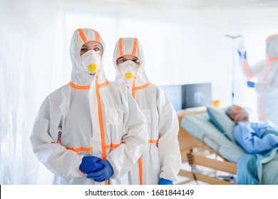 Doctors And Infected Patient In Quarantine Lying In Bed In Hospital, Coronavirus Concept.