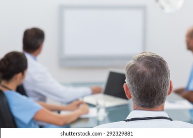 Doctors Looking At White Board In Meeting