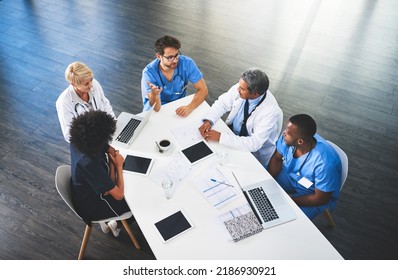 Doctors, Medical Professionals And Workers Talking In A Meeting, Discussing A Strategy And Making Plans While Working At Hospital. Clinic Employees Having Discussion In Seminar, Workshop Or Training