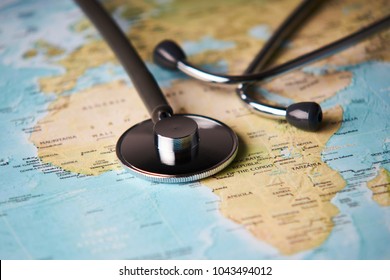 Doctor's medical stethoscope over africa healthcheck. Medical concept tourism travel care diseases healthy, close-up. Selective focus - Shutterstock ID 1043494012