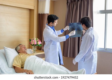 Doctors of the medical team describe the x-ray film of the pulmonary illness of the elderly, the atmosphere in the patient room in the clinic - Powered by Shutterstock