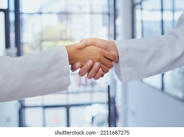 Doctors Meeting, Shaking Hands And Partner At Hospital With Lab Coats. Scientist Or Doctor Agree On Medical Business, Support And Cooperate Together With Handshake To Show Collaboration And Teamwork