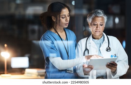 Doctors, nurse and digital tablet for night teamwork, medical research and surgery planning in wellness hospital. Talking, healthcare and worker women in collaboration on technology for late thinking - Powered by Shutterstock