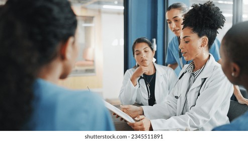 Doctors, nurse and women on clipboard in meeting, collaboration or teamwork for hospital planning, medical or life insurance. Talking, leadership and healthcare workers on paper in diversity research - Powered by Shutterstock