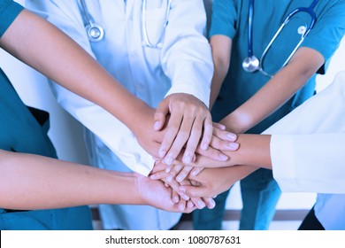 Doctors and nurses coordinate stacking hands together at hospital, Concept Teamwork, happy doctors working together as the team for motivation, success medical health care, blue tone color