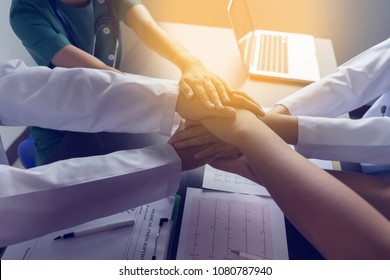 Doctors and nurses coordinate stacking hands together at hospital, Concept Teamwork, happy doctors working together as the team for motivation, success medical health care, blue tone color