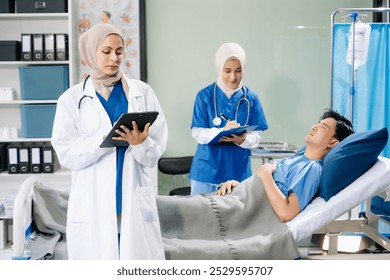 Doctors and nurses in hijabs offering care to a patient in a hospital ward, showcasing teamwork, professionalism, and a compassionate healthcare environment. - Powered by Shutterstock