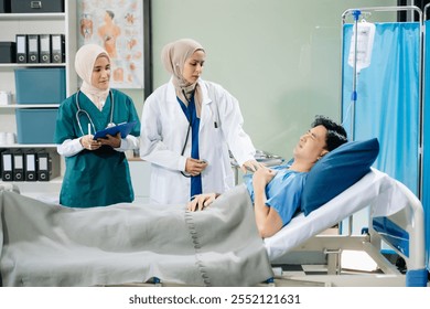 Doctors and nurses in hijabs offering care to a patient in a hospital ward, showcasing teamwork, professionalism, and a compassionate healthcare environment. - Powered by Shutterstock