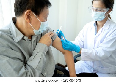Doctors or nurses are preparing vaccines from vials to syringes for injection to people for prevention of Coronavirus disease covid-19 - Shutterstock ID 1927354643