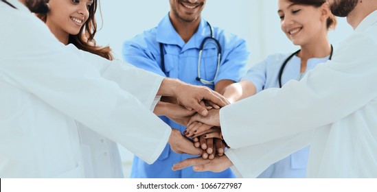 Doctors And Nurses Stacking Hands. Concept Of Mutual Aid.