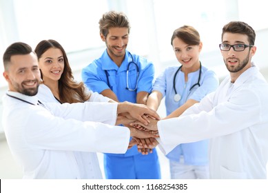 Doctors And Nurses Stacking Hands. Concept Of Mutual Aid.