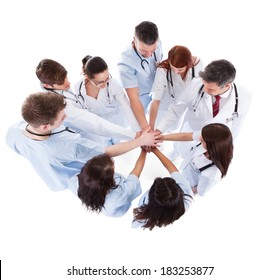 Doctors and nurses stacking hands. Isolated on white - Powered by Shutterstock