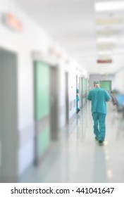 Doctors And Nurses Walking In Hospital Hallway, Blurred Motion.