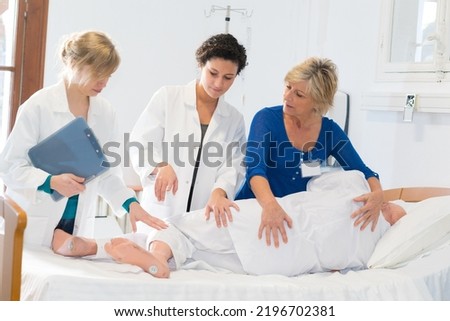 doctors and nurses working on patient in emergency room