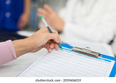 At the doctor's office, the patient completes a declaration on COVID-19 - Shutterstock ID 2059606019