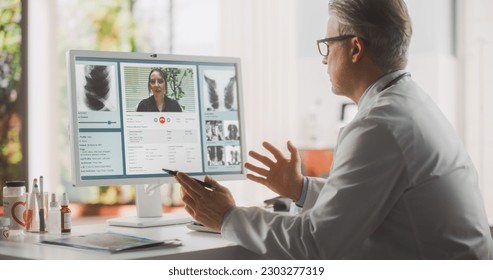 Doctor's Online Medical Consultation: Caucasian Middle Aged Physician Making a Conference Video Call with a Patient on a Computer. Health Care Professional Giving Advice, Explaining Treatment - Powered by Shutterstock