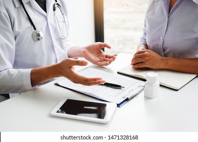 Doctors And Patients Consulting About Treatment Guidelines At Office