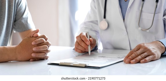 Doctors And Patients Consulting About Treatment Guidelines At The Office