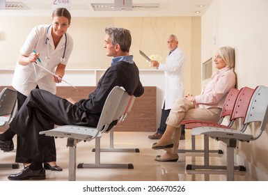 Doctors And Patients In Hospital Waiting Room.