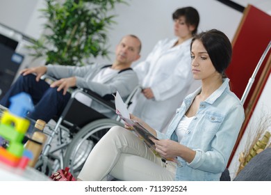 Doctors And Patients In Hospital Waiting Room