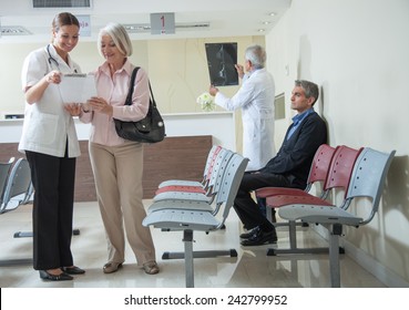 Doctors And Patients Speaking In The Hospital Waiting Room.