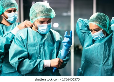 Doctors preparation for surgical operation in hospital during corona virus outbreak - Medical workers getting ready for fighting against coronavirus pandemic - Healthcare medicine concept  - Shutterstock ID 1756406570