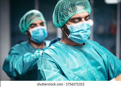 Doctors preparation for surgical operation in hospital during corona virus outbreak - Medical workers getting ready for fighting against coronavirus pandemic - Healthcare medicine concept - Shutterstock ID 1756571315