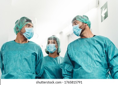 Doctors preparing for surgical operation in hospital during corona virus outbreak - Medical workers getting ready for fighting against coronavirus pandemic - Healthcare medicine concept  - Powered by Shutterstock