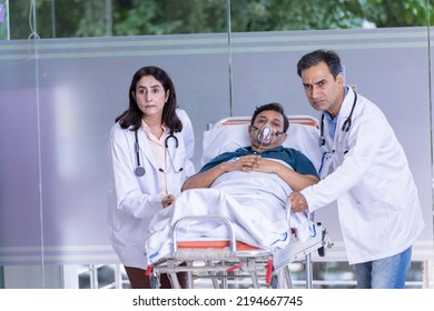 Doctors pushing old patient on emergency stretcher bed - Powered by Shutterstock