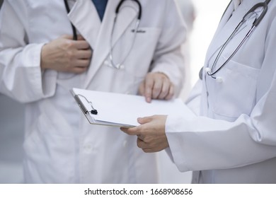 Doctors Reviewing Medical Charts In Meeting