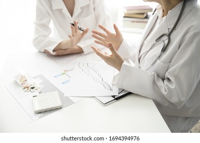 Doctors Reviewing Medical Data In Meeting